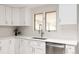 Modern kitchen featuring sleek countertops, stainless steel appliances, and bright light at 3540 Everett St, Wheat Ridge, CO 80033