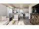 Open-concept living space with plank floors, kitchen, and natural light is ideal for relaxing and entertaining at 3540 Everett St, Wheat Ridge, CO 80033