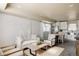 Bright living room with stylish white paneling, modern furniture, and open layout to dining area and kitchen at 3540 Everett St, Wheat Ridge, CO 80033