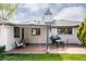 Brick patio includes black table and chairs, grill, and plenty of space for outdoor relaxation and dining at 3540 Everett St, Wheat Ridge, CO 80033