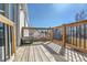 Wooden back deck with metal railing overlooking the neighborhood at 11278 W 103Rd Dr, Broomfield, CO 80021