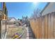 View of a large backyard with a play area, fire pit, and fence at 11278 W 103Rd Dr, Broomfield, CO 80021