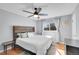 A cozy bedroom features a modern ceiling fan and a dark wood accent headboard at 11278 W 103Rd Dr, Broomfield, CO 80021