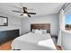 A cozy bedroom features a modern ceiling fan and a dark wood accent headboard at 11278 W 103Rd Dr, Broomfield, CO 80021