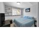 Bedroom with a large window, built in bookshelves and a blue comforter at 11278 W 103Rd Dr, Broomfield, CO 80021