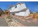 A two-story house with a wooden deck, white siding, a stone garden, and a well-maintained backyard at 11278 W 103Rd Dr, Broomfield, CO 80021