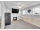 Cozy living room with a fireplace, TV, and built in bookshelves at 11278 W 103Rd Dr, Broomfield, CO 80021