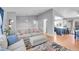 Open concept living room flows into the kitchen with hardwood floors and light gray walls at 11278 W 103Rd Dr, Broomfield, CO 80021