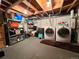 Unfinished basement laundry area with washer, dryer and shelving at 1322 Kalamath St, Denver, CO 80204