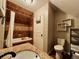 Nicely tiled bathroom featuring a bathtub, toilet, vanity with a granite countertop, and neutral paint at 1322 N Kalamath St, Denver, CO 80204