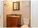 Cozy bathroom featuring a granite countertop, a classic toilet, and warm natural light at 1322 N Kalamath St, Denver, CO 80204