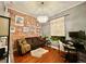 Stylish bedroom featuring a brick accent wall, a plush sofa, and a modern chandelier at 1322 Kalamath St, Denver, CO 80204