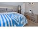 Bedroom featuring neutral colored walls, carpet, and a blue blanket on the bed at 1322 N Kalamath St, Denver, CO 80204