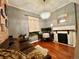 Inviting bedroom with a decorative fireplace, a cozy couch, and warm hardwood floors at 1322 N Kalamath St, Denver, CO 80204