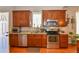 Kitchen featuring stainless steel appliances, granite countertops, and wooden cabinets at 1322 Kalamath St, Denver, CO 80204