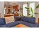 Cozy living room featuring a comfortable sectional sofa, hardwood floors, and an open layout with a kitchen view at 1322 N Kalamath St, Denver, CO 80204