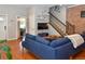 Stylish living room with hardwood floors, exposed brick, and a staircase featuring dark iron railings at 1322 N Kalamath St, Denver, CO 80204