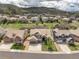 Stunning aerial view of suburban homes boasting meticulous landscaping and mountain views under a cloudy sky at 5010 Persimmon Ln, Castle Rock, CO 80109