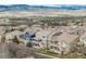 Aerial view of a residential area with houses and scenic mountain views at 5010 Persimmon Ln, Castle Rock, CO 80109