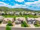 A high angle of several two story homes in a community with green spaces and rolling hills in the background at 5010 Persimmon Ln, Castle Rock, CO 80109