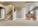 View of the basement stairs, carpeted floor, and seating area with natural light through the sliding glass door at 5010 Persimmon Ln, Castle Rock, CO 80109