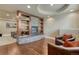 Basement with stone fireplace, entertainment center, leather seating and wood flooring at 5010 Persimmon Ln, Castle Rock, CO 80109