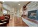 View of a finished basement with a stone fireplace, wooden floors, and a wet bar at 5010 Persimmon Ln, Castle Rock, CO 80109