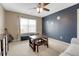 Comfortable bedroom with dark blue accent wall, ceiling fan, and plenty of natural light at 5010 Persimmon Ln, Castle Rock, CO 80109