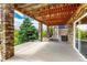 An outdoor covered patio with stone columns, an outdoor swing and view of the backyard at 5010 Persimmon Ln, Castle Rock, CO 80109