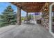 Covered patio with stone pillars and an outdoor swing, perfect for relaxation at 5010 Persimmon Ln, Castle Rock, CO 80109