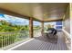 Covered deck with outdoor seating, a grill, stone support columns and neighborhood views at 5010 Persimmon Ln, Castle Rock, CO 80109