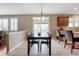 Cozy dining room with seating for six, tiled floors, and bright lighting from adjacent windows at 5010 Persimmon Ln, Castle Rock, CO 80109