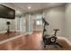 Exercise room with mirrored walls, hardwood floors, open doorway, and exercise equipment at 5010 Persimmon Ln, Castle Rock, CO 80109