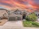 Beautiful two-story home with a three-car garage, stone accents and landscaped front yard at 5010 Persimmon Ln, Castle Rock, CO 80109