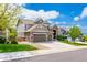 Attractive two-story home with a stone and siding exterior, a two-car garage, and well-maintained landscaping at 5010 Persimmon Ln, Castle Rock, CO 80109