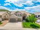 Charming two-story home with a three-car garage, stone accents, lush lawn, and beautiful curb appeal at 5010 Persimmon Ln, Castle Rock, CO 80109