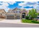 Charming two-story home with a stone and siding exterior, two-car garage, and well-manicured lawn at 5010 Persimmon Ln, Castle Rock, CO 80109