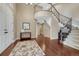 Grand foyer with hardwood floors, a curved staircase and soaring ceilings at 5010 Persimmon Ln, Castle Rock, CO 80109