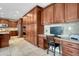 Eat-in kitchen with abundant cabinet space, stainless appliances, desk area, and tile flooring throughout at 5010 Persimmon Ln, Castle Rock, CO 80109