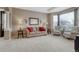 Formal living room with neutral carpet, crown molding, and a large window with natural light at 5010 Persimmon Ln, Castle Rock, CO 80109