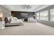 Primary bedroom featuring a large bedroom suite, tray ceilings, and large windows with views at 5010 Persimmon Ln, Castle Rock, CO 80109
