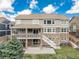 Rear exterior showcasing a multi-level deck, stone accents, and a well-maintained lawn at 5010 Persimmon Ln, Castle Rock, CO 80109
