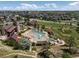 Overhead view of a community recreation area featuring pools, buildings, and green spaces at 11945 S Saunter Ln, Parker, CO 80138