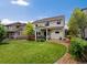 Spacious backyard with lush lawn, patio, and mature trees at 11945 S Saunter Ln, Parker, CO 80138