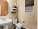 Well lit powder room features a pedestal sink and decor shelves at 11945 S Saunter Ln, Parker, CO 80138