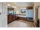 Well-lit bathroom features double vanity, soaking tub, and glass shower at 11945 S Saunter Ln, Parker, CO 80138
