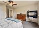 Comfortable bedroom with a ceiling fan, neutral colors, and carpeted floors at 11945 S Saunter Ln, Parker, CO 80138