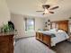 A spacious bedroom features natural light, a ceiling fan, and neutral décor at 11945 S Saunter Ln, Parker, CO 80138
