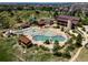 Aerial view of community pool complex with pools, lounge chairs, and recreational facilities in a residential area at 11945 S Saunter Ln, Parker, CO 80138