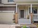 Welcoming entryway with a stone-accented facade, cozy porch, and neat landscaping at 11945 S Saunter Ln, Parker, CO 80138